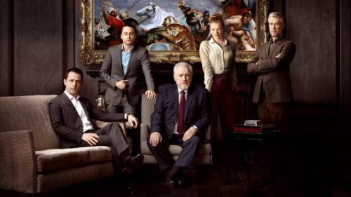 HBO Succession cast seated posing for a serious photo.